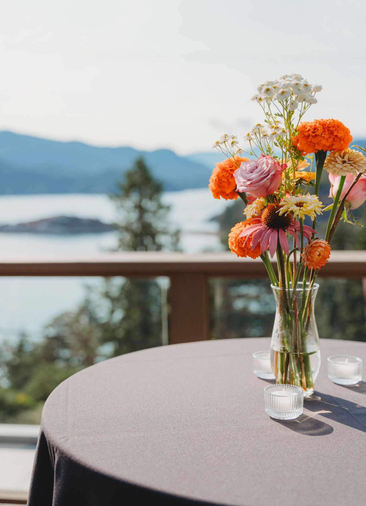 Beautifully styled event table with floral centrepiece and ocean view